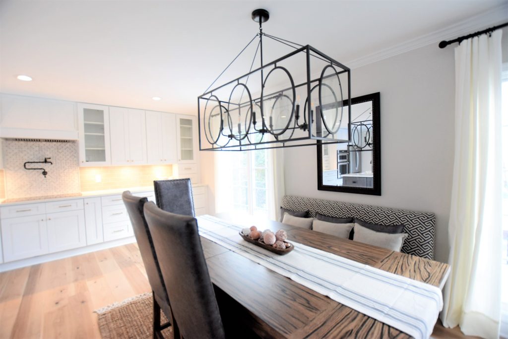 Ballard designs chandelier
Calcatta laza Quartz by MSI, ice white shaker cabinets, engineered wide plank flooring, Kitchen Aid Appliances, induction cooktop, large farmhouse table, kitchen banquette seating